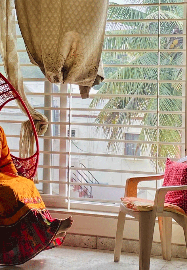 Indian grandmother seated in her living room while at rest