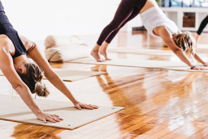 Women in Downward-Facing Dog during yoga class